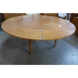 A Danish Dyrlund teak circular flip flap dining table