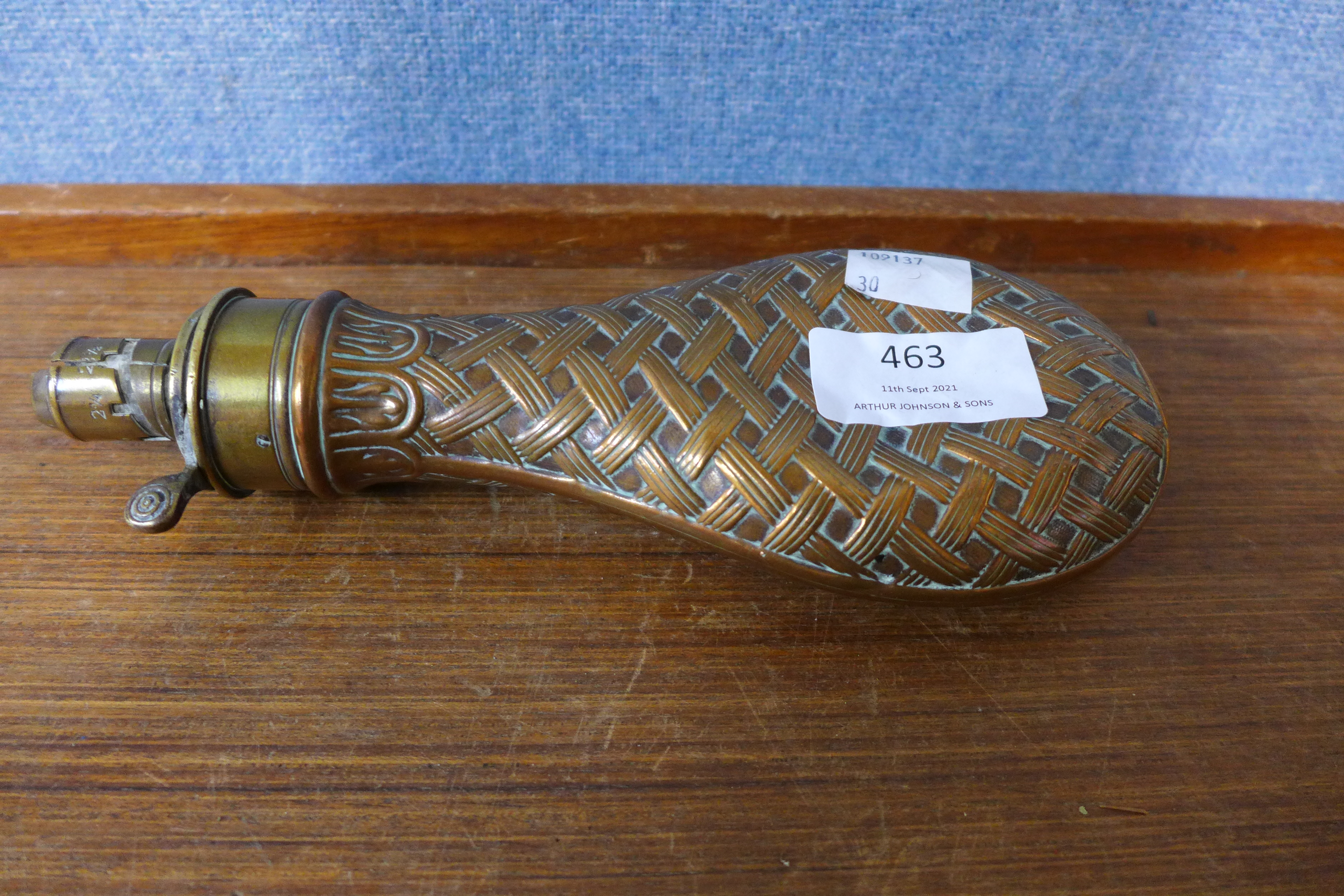 A copper and brass gun powder flask