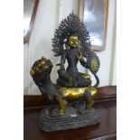 A large oriental gilt bronze figure of a seated deity, 82cms h