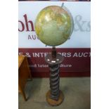 A vintage terrestrial globe , on carved beech barleytwist stand