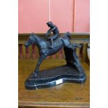 A bronze figure of a horse and jockey, on black marble plinth, 33cms h