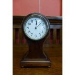 An early 20th Century French inlaid mahogany balloon shaped mantel timepiece