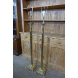 A pair of brass Corinthian column floor standing lamps