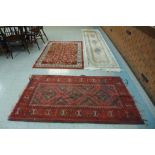 Two red ground rugs and a Chinese runner rug