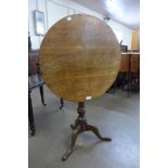 A George III oak circular tilt top tripod table