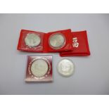 Three Singapore 50% commemorative silver coins and one other Singapore coin