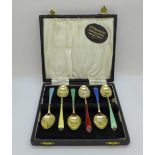 A cased set of six Art Deco silver gilt and enamel spoons
