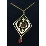 A 9ct gold and red stone pendant and chain, 1.7g