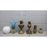 A collection of oil lamps with glass shades