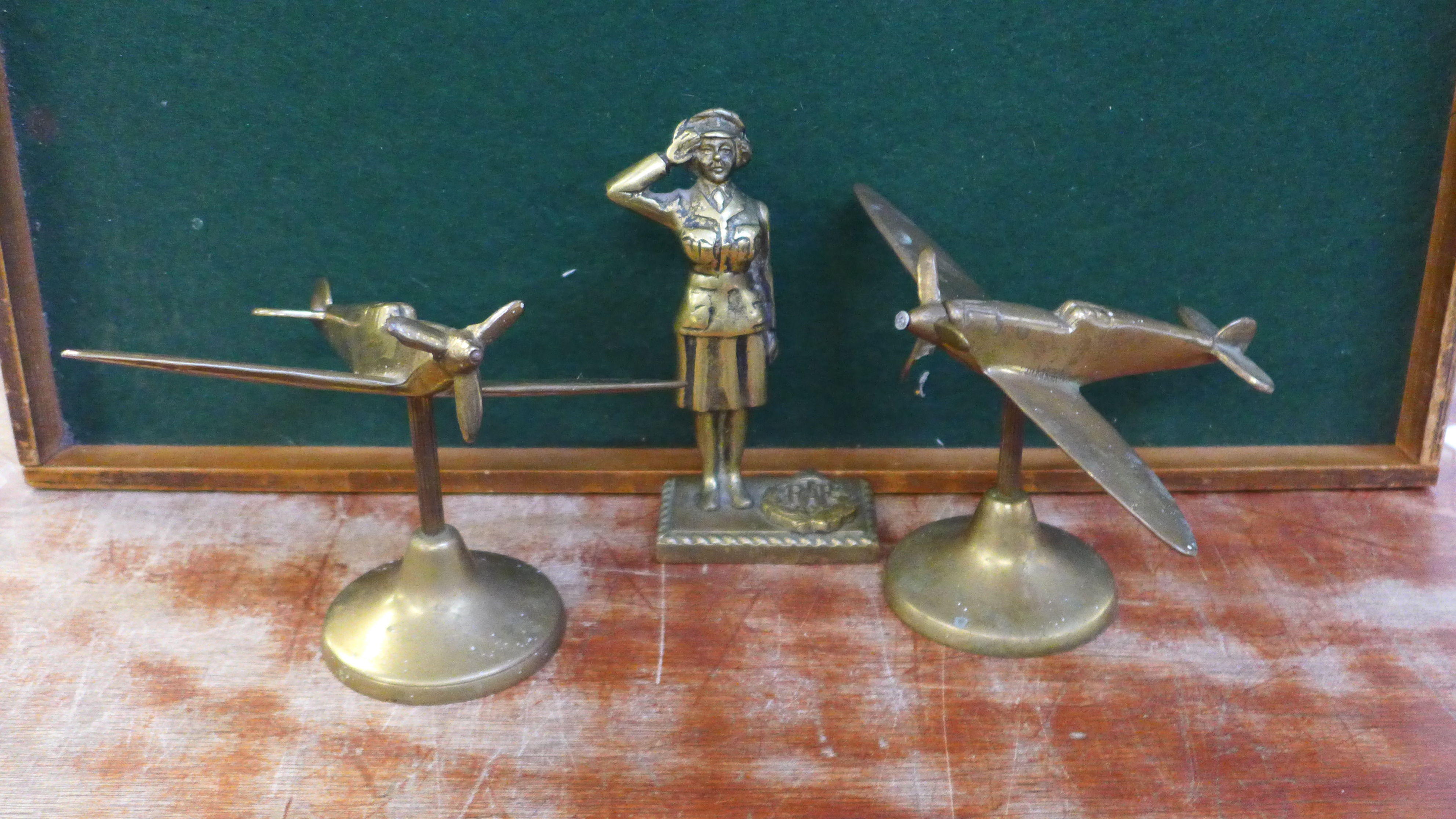 Two brass models of Spitfires and a brass model of a RAF wren