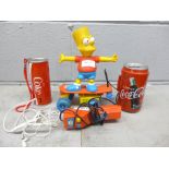 A The Simpsons Bart skateboard toy, a Coke camera and cassette player