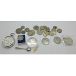 A collection of coins including silver, a silver pocket watch and a silver salt spoon