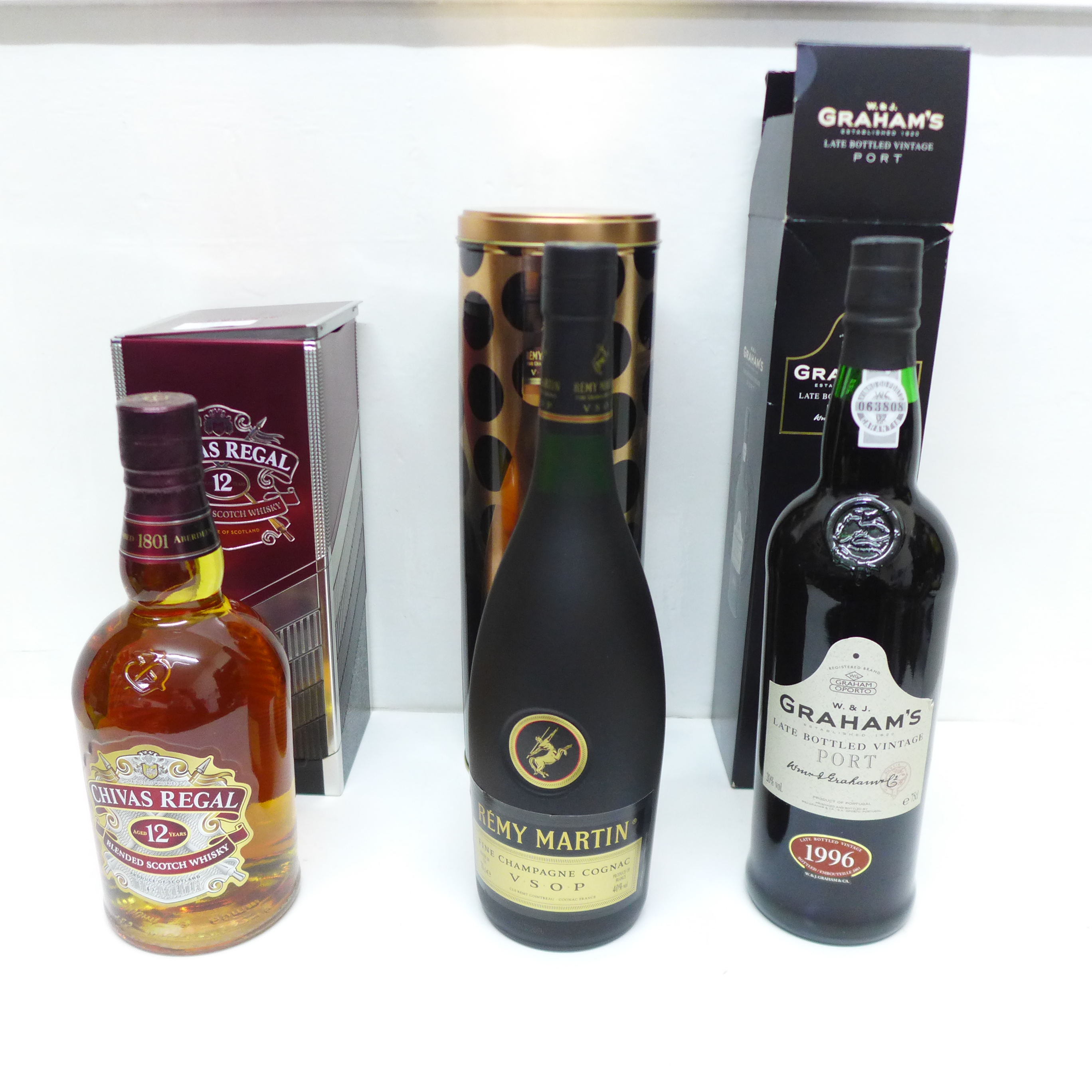 A bottle of Graham's vintage port, Chivas Scotch whisky and Remy Martin Champagne Cognac