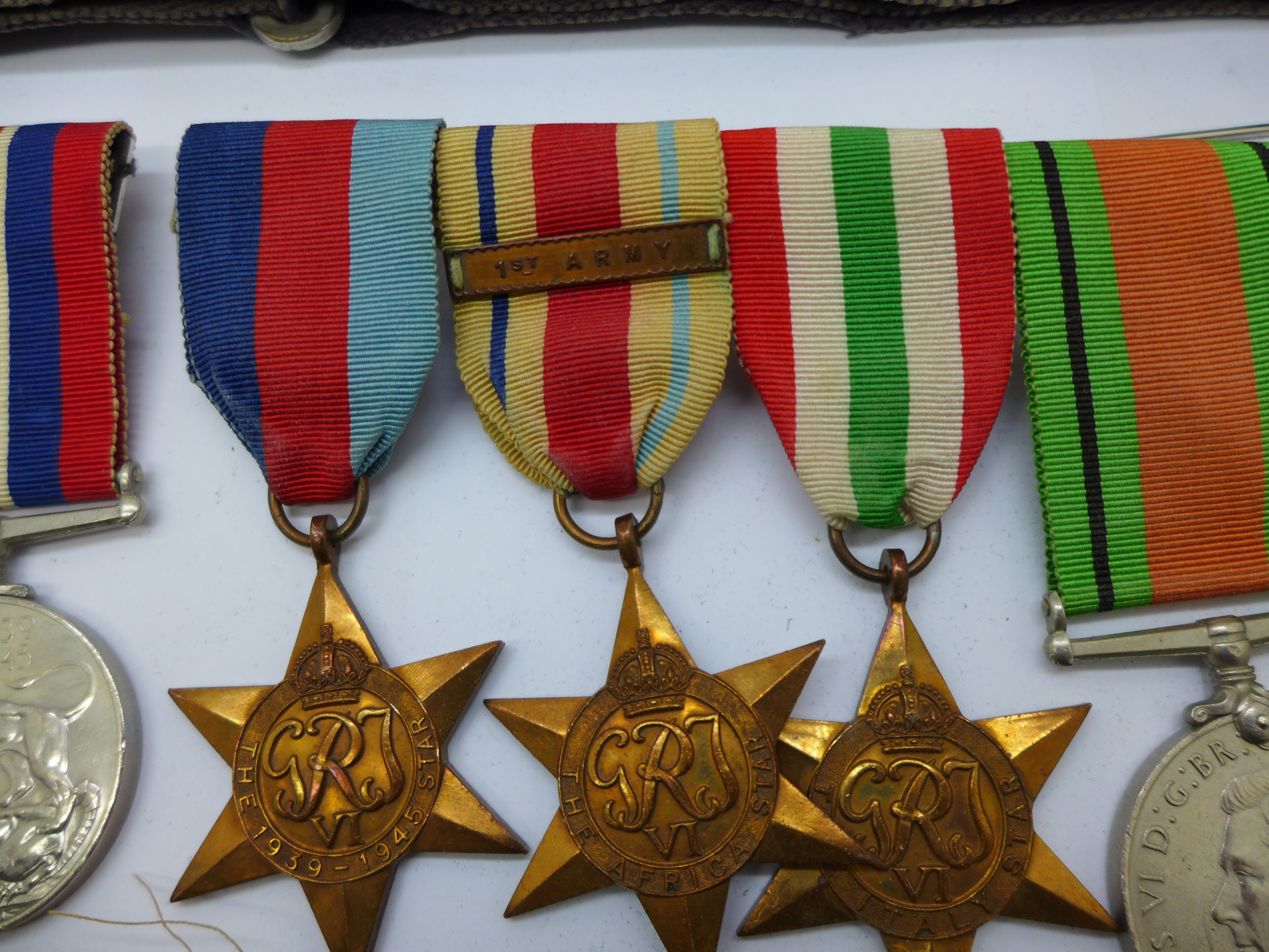 A collection of WWII medals including one group with 1st Army clasp, a silver Fearnaught badge and a - Bild 5 aus 5