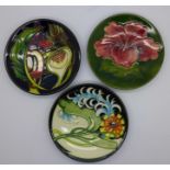 Three Moorcroft dishes, including early 20th Century hibiscus pattern and one 2007 Collectors Guild