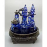 A silver six bottle cruet, bottles in cut glass Bristol blue, the base hallmarked London 1828, one