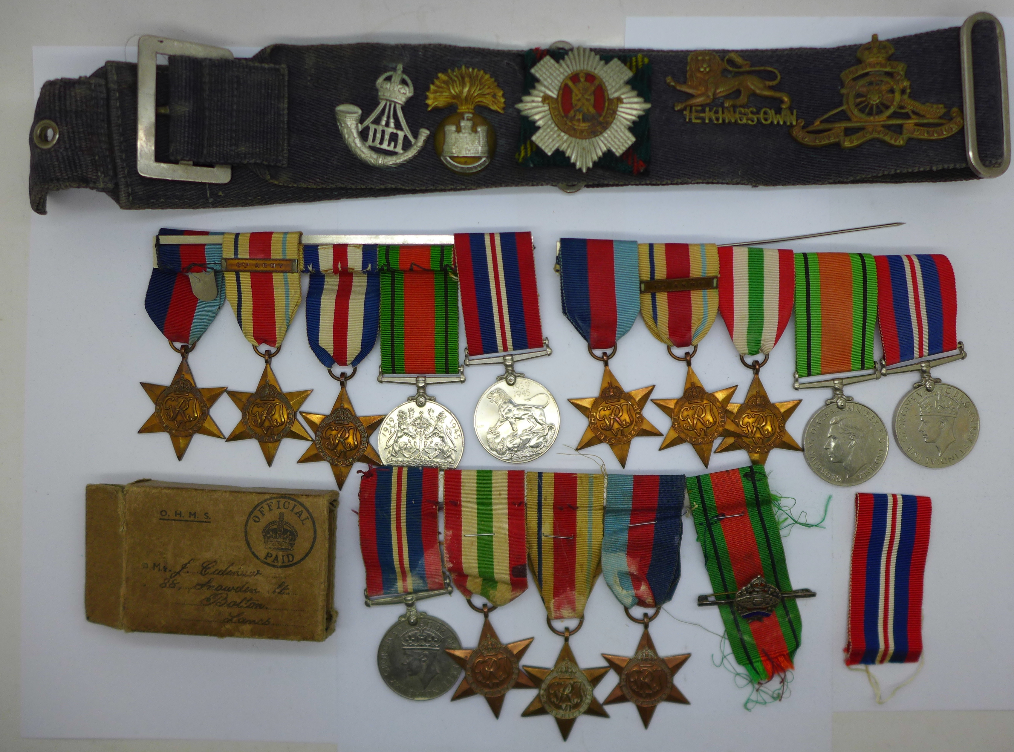 A collection of WWII medals including one group with 1st Army clasp, a silver Fearnaught badge and a