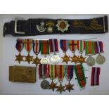 A collection of WWII medals including one group with 1st Army clasp, a silver Fearnaught badge and a