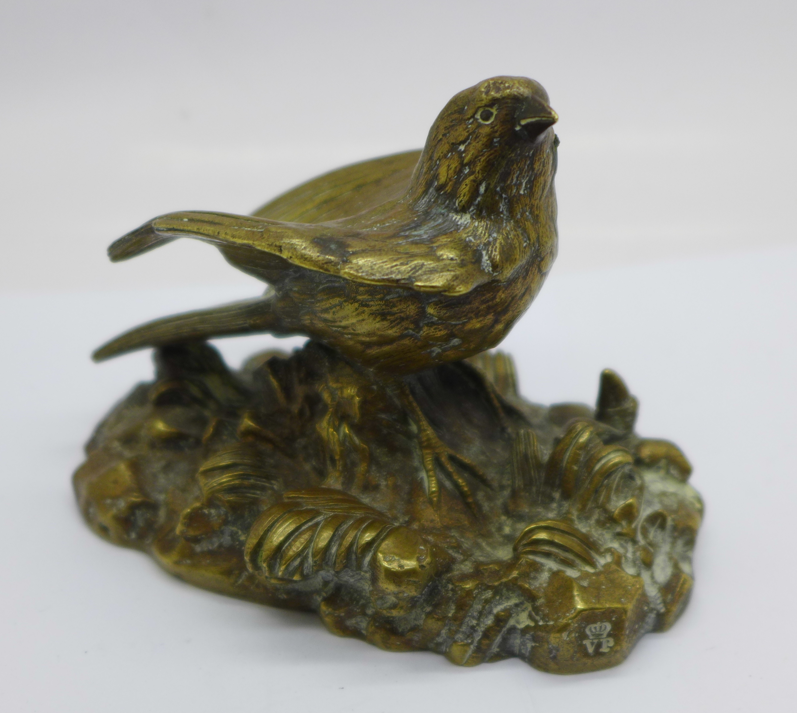 A bronze model of a bird, signed