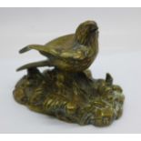 A bronze model of a bird, signed