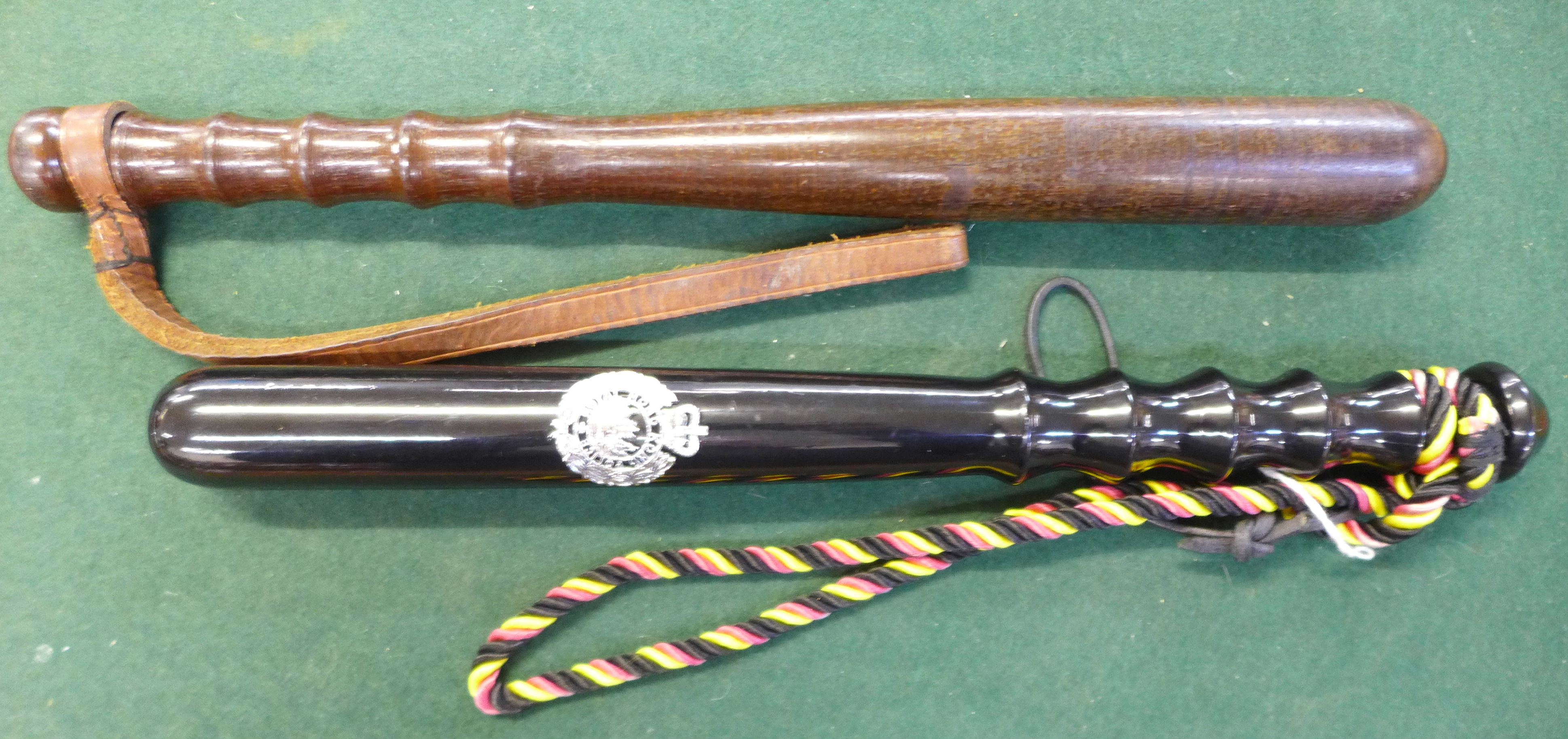 A wooden truncheon and one other truncheon with applied Hong Kong Police badge