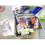 A collection of motorsport memorabilia including tickets, programmes, cards, signed items,