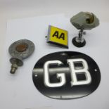 A RAC badge, an AA badge, a GB plaque and a car compass