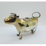 A George III 18th Century silver cow creamer, one leg restored, crease to left hand side, length