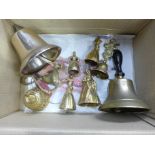 A bronze and turned wooden handle hand bell, one other wall mounted bell and other brass bells