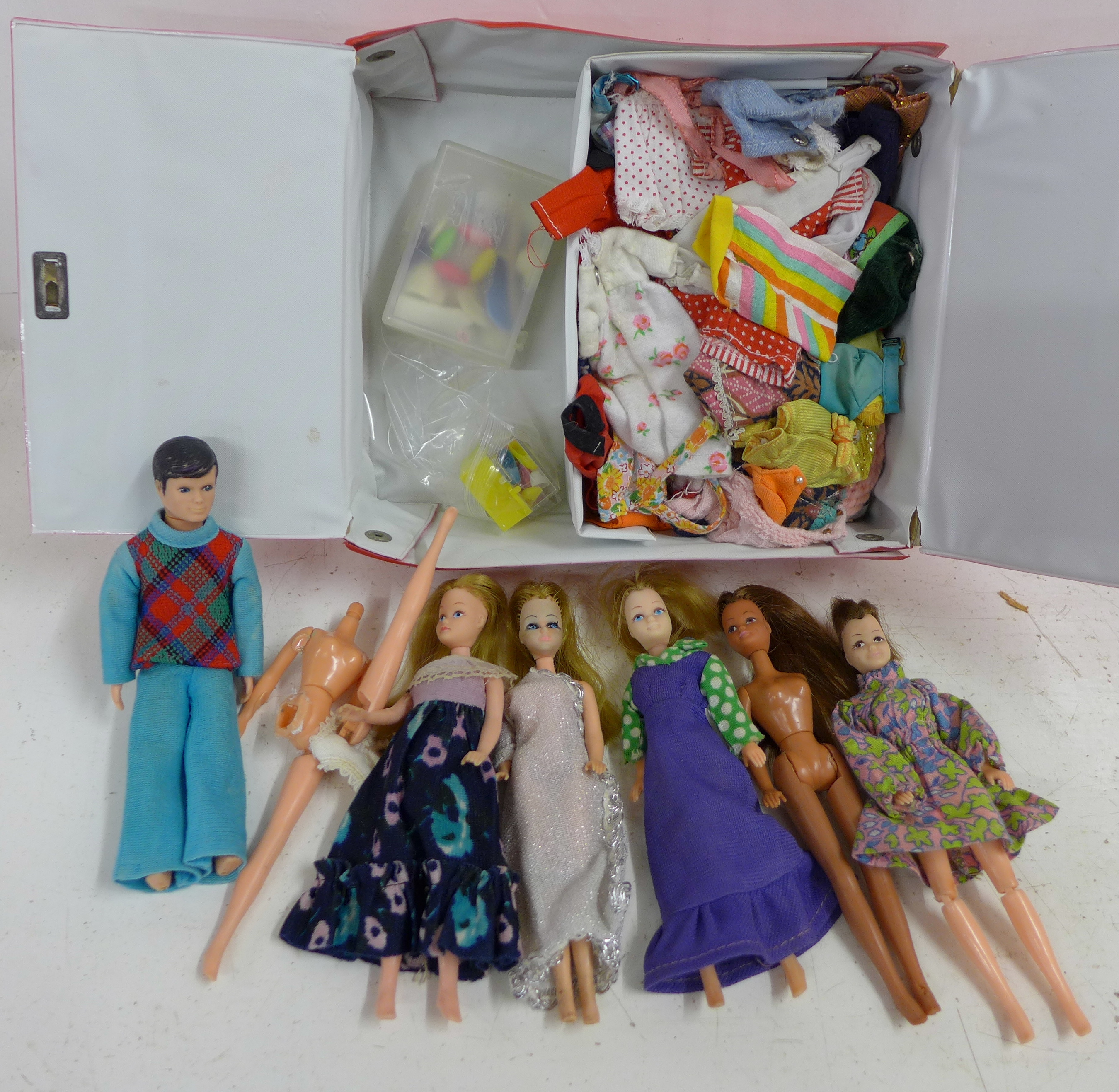 A collection of dolls and clothing in a Pippa case, some a/f