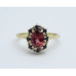 A 9ct gold, red stone, sapphire and diamond cluster ring, 2.3g, L