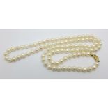 A long cultured pearl necklace with 18ct gold clasp