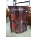 A George III Happlewhite style inlaid mahogany serpentine hanging corner cabinet