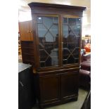 A George III oak freestanding splay front corner cabinet