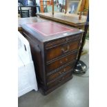 A mahogany and red leather topped filing cabinet