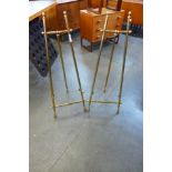 A pair of brass easels, 108cms h