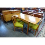 A Gordon Russell oak and walnut six piece dining suite, comprising; sideboard, extending table and