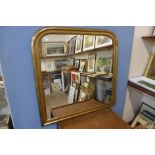 A gilt framed overmantel mirror