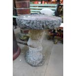 A concrete bird bath