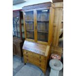 A carved oak bureau bookcase