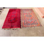 Two eastern red ground rugs, 180 x 106cms and 177 x 90cms