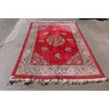 A Chinese red ground rug, 245 x 180cms