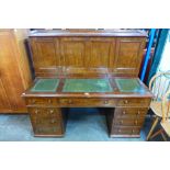 A Victorian mahogany and green leather topped Dickens desk