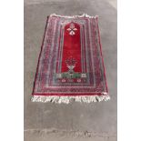 An eastern red ground rug, 155 x 94cms