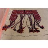 An eastern hand knotted red ground wall hanging, 142cms w