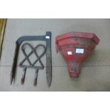 A cast iron drain hopper and two wrought iron boot scrapers