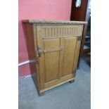 A Cotswold School oak single door side cabinet