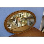 An oak framed oval mirror