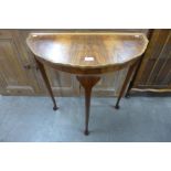 A walnut demi-lune hall table