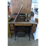 An oak and cast iron Singer treadle sewing machine